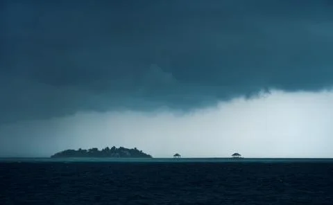 Dramatic Tropical Storm Over Island Lagoon 库存照片