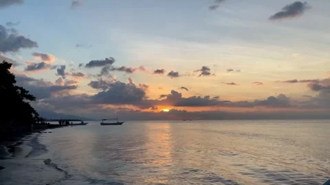 Dramatic Tropical Sunset Over Calm Sea Horizon in Bali Stock Footage 335600219