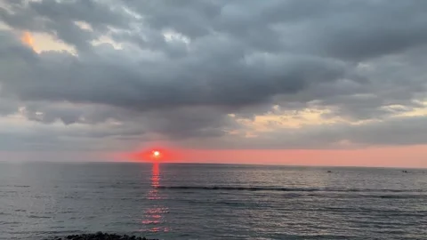 Dramatic Tropical Sunset over Calm Ocean with Moody Clouds Stock Footage 340216451