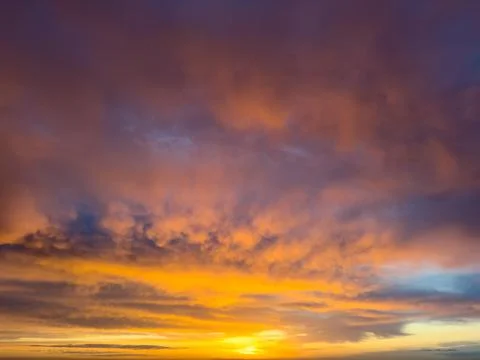 Dramatic twilight clouds glowing in warm hues Photos