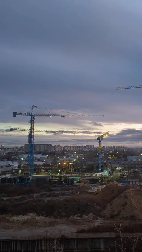 Dramatic Twilight Construction Site with Illuminated Tower Cranes in Urban .. Stock Footage 301787333