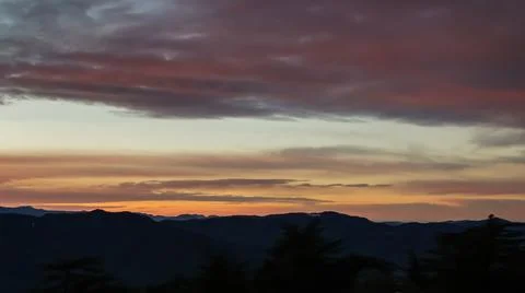Dramatic twilight orange sky above himalayan peaks at dawn Фото