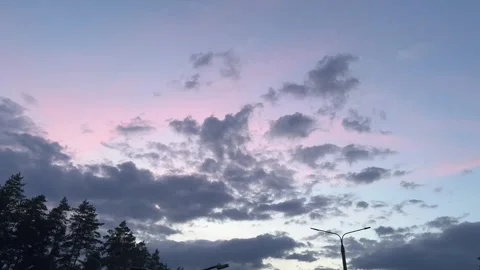 Dramatic twilight sky with dark clouds and tree silhouettes Stock-Footage 336104173