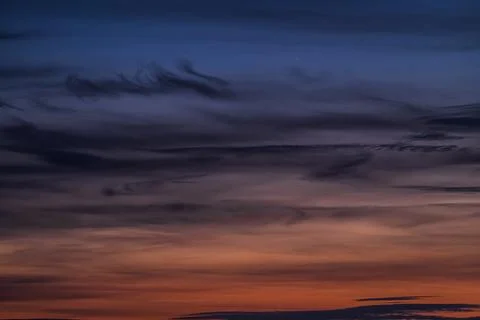 Dramatic twilight sky with dark clouds and gradient colors. Stock Photos