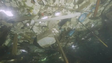 Dramatic underwater environment polluted with nylons and plastics in a fresh Stock-Footage 254471177