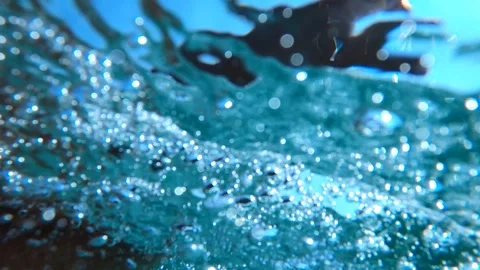 Dramatic underwater scene of male hand reaching toward the ocean surface wi.. Stock Footage 331535109