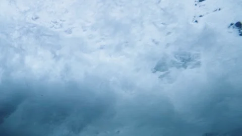 Dramatic underwater shot of turbulent ocean waves breaking with white foam .. Vídeo Stock 341210119
