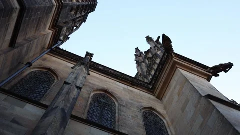 A dramatic upward view of a Gothic cathedral exterior, showcasing intricate arch Stock Footage 294781399