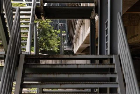 Dramatic upward view of a multi-tiered outdoor steel staircase utilizes pow.. Stock Photos