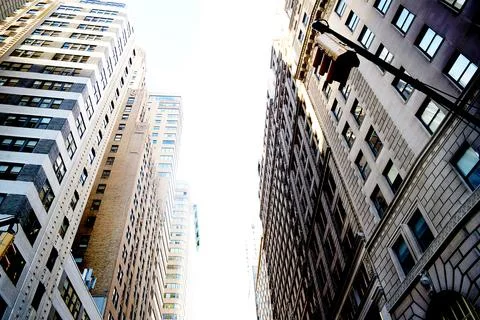 Dramatic upward view of towering skyscrapers in vibrant city center evokes Stock Photos