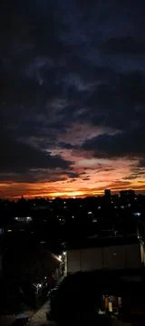 Dramatic Urban Sunset With Dark Clouds Stock Photos