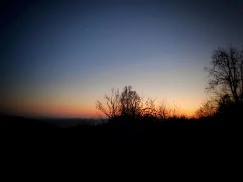 Dramatic Valley Landscape with Orange Sunlight and Deep Blue Sky 写真素材