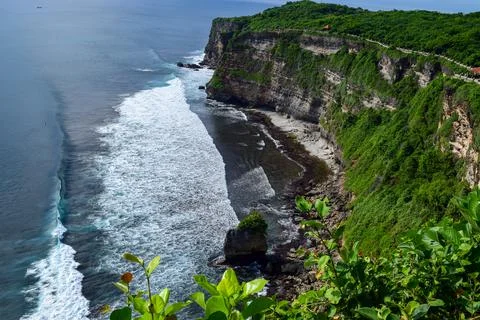 Dramatic vertical sea cliffs, with vast ocean expanse, white waves crashing o Photos