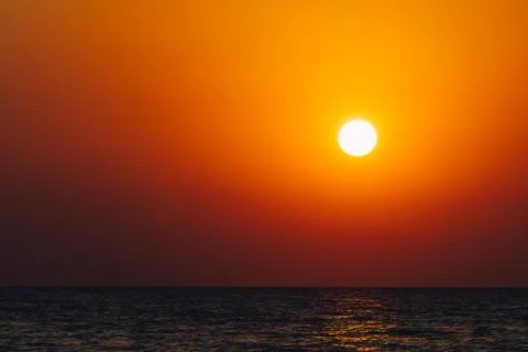 Dramatic vibrant sun over ocean 写真素材