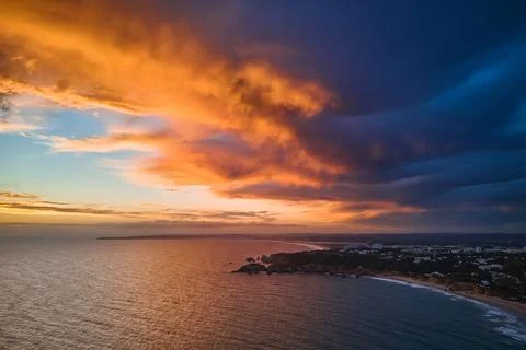 Dramatic vibrant sunset cloudscape over the Algarve coastline Stock Photos