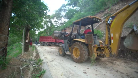 Dramatic video of road workers with tractor high in caribbean mountains. Stock Footage 139488166