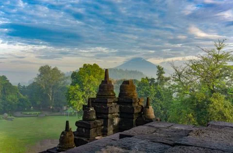 Dramatic view of ancient stupa borobudur temple with Mount Merapi in backgrou Stock Photos