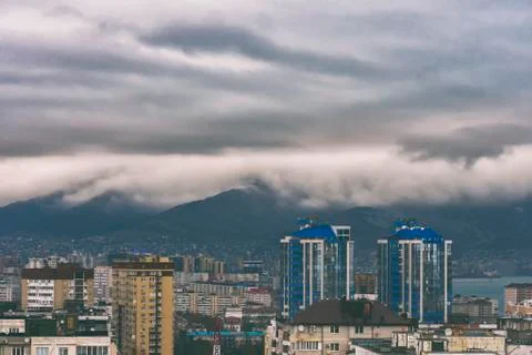 Dramatic view of the buildings in the mountains overcast sky and raining at r Stock Photos