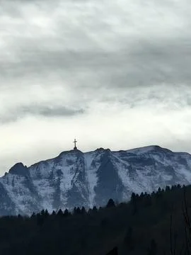 Dramatic view of Caraiman Peak with the Heroes' Cross in winter. Stock Photos