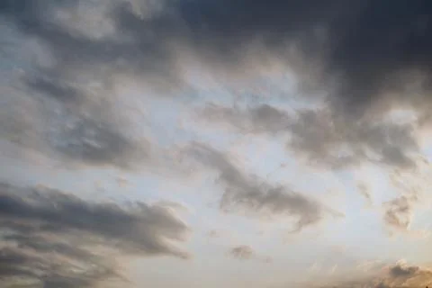 A dramatic view of a cloudy sky with thick layers of grey cumulus clouds Stock Photos