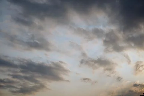 A dramatic view of a cloudy sky with thick layers of grey cumulus clouds Stock Photos