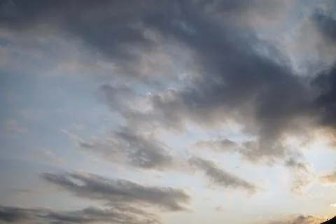 A dramatic view of a cloudy sky with thick layers of grey cumulus clouds Stock Photos