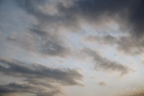 A dramatic view of a cloudy sky with thick layers of grey cumulus clouds Stock Photos