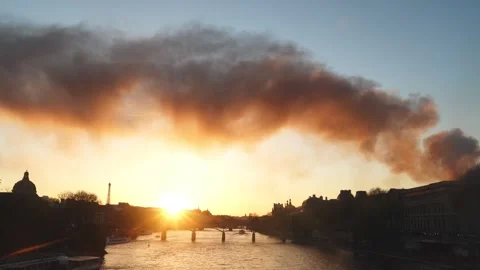 Dramatic view of a column of smoke in Paris in the Seine River at sunset Stock Footage 312872202