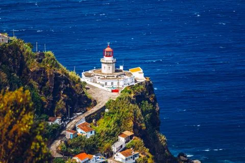 Dramatic view down to lighthouse on Ponta do Arnel, Nordeste, Sao Miguel Isla Stock Photos