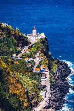 Dramatic view down to lighthouse on Ponta do Arnel, Nordeste, Sao Miguel Isla Stock Photos