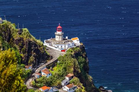 Dramatic view down to lighthouse on Ponta do Arnel, Nordeste, Sao Miguel Isla Stock Photos