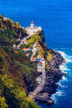 Dramatic view down to lighthouse on Ponta do Arnel, Nordeste, Sao Miguel Isla Stock Photos