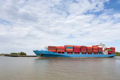 Dramatic View of Fully Loaded Container Ship Stock Photos