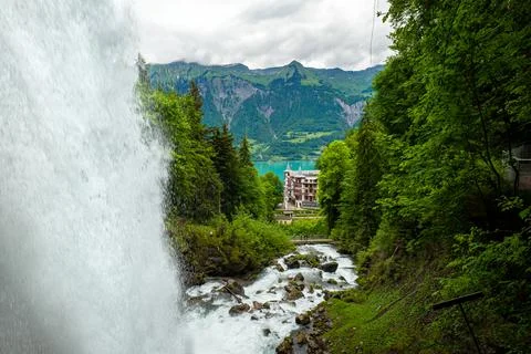 Dramatic view of the Giessback waterfall and Grand Hotel Giessbach in the dis Fotos de archivo