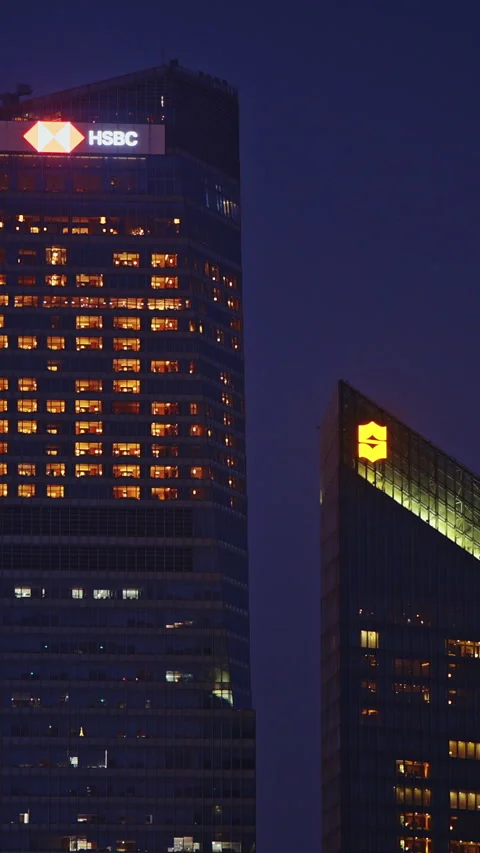 Dramatic View of HSBC and City Towers Illuminated at Nighttime Stock Footage 336350705