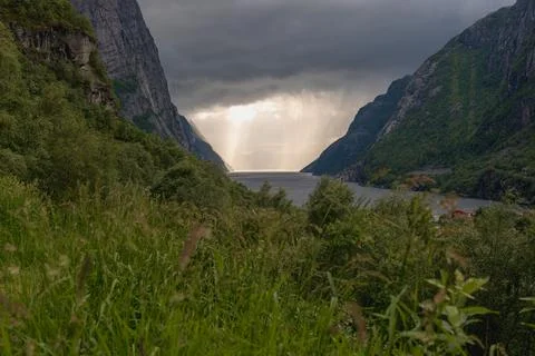 Dramatic View of Lysefjord with Rugged Cliffs and Storm Clouds Stock Photos