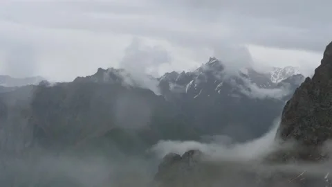 Dramatic view of Medeo mountain peaks under low clouds Stock Footage 314231683