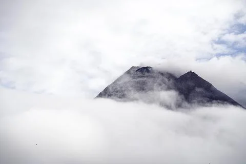 The dramatic view of Mount Merapi covered in clouds is very dense. Mountain.. Stock Photos