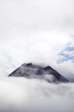 The dramatic view of Mount Merapi covered in clouds is very dense. Mountain.. Stock Photos