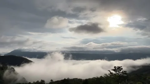 Dramatic View of Mountain Range Above Clouds at Sunrise China Stock Footage 338419338