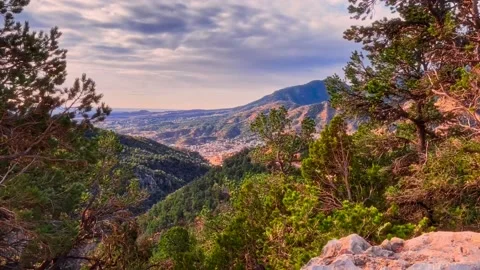 Dramatic view of mountains and ravine offset against colorful sky and clouds Stock Footage 219894830