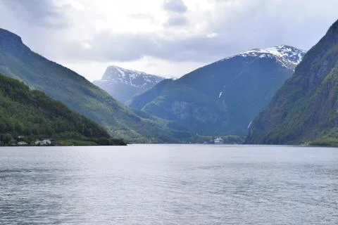 Dramatic view of mountains covered with snow from the sea Stock Photos