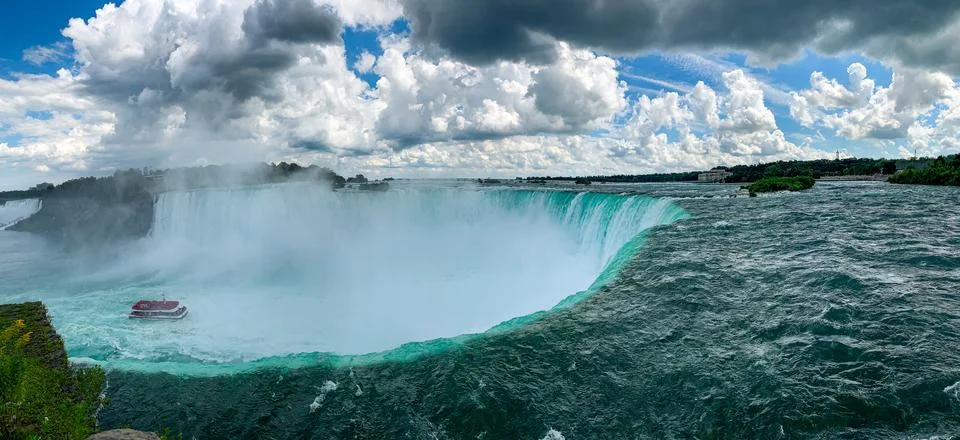 Dramatic view of Niagara Fall from the top with a boat inside in Canada Stock Photos