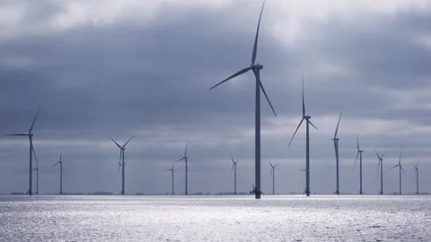 Dramatic view of an offshore wind farm in the early morning light Stock Footage 243568938