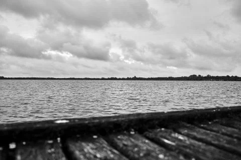 A dramatic view over a German lake with a rotten pier in the foreground Stock Photos