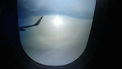 Dramatic view from Pegasus airplane window on the clouds and the sun Stock Footage 152604368