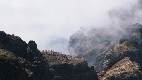 Dramatic view from Pico do Arieiro with hikers on rugged volcanic ridges Видео 345841023