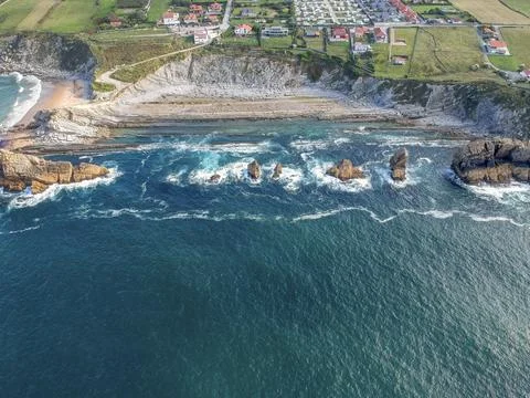 Dramatic view of Playa de la Arnia, rocky coastline in Santander ,Cantabria Photos