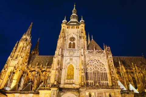 Dramatic view of the Prague Castle illuminated by warm yellow lights in a dar Stock Photos