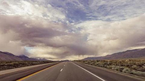 Dramatic view of road with cloudy and smokey sky from nearby fires Stock Photos
